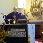 Zdjęcie księdza stojącego przy ołtarzu